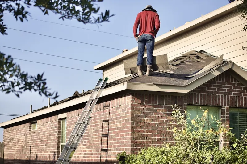 Professional roofer working on a residential roof in Forbes Village